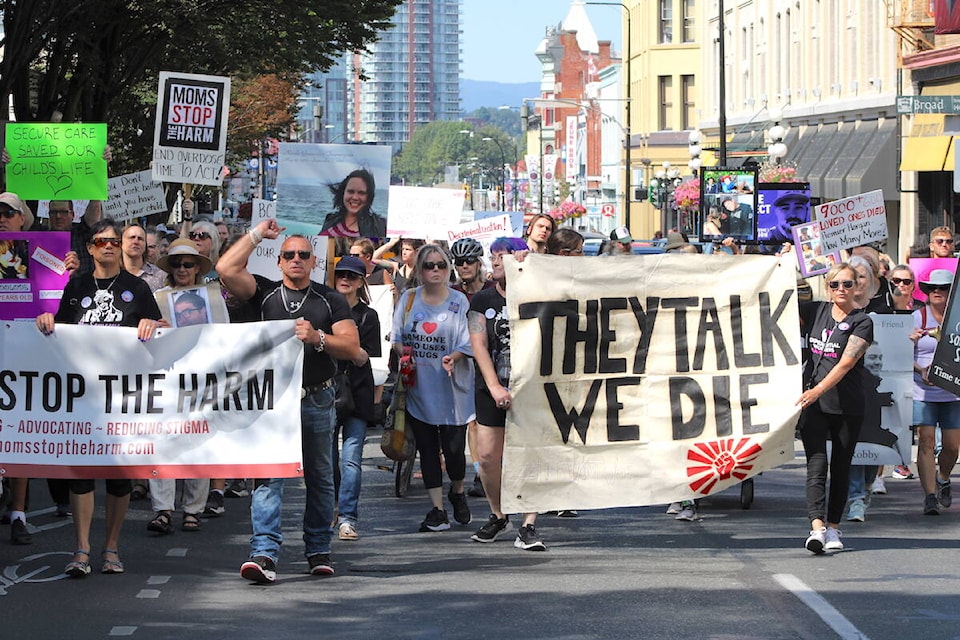 Attendees of an International Overdose Awareness Day event march through downtown Victoria on Aug. 31. (Jake Romphf/News Staff)