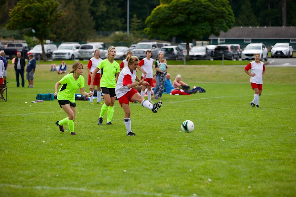 Wendy Gibbons of Alpha (white jersey) kicks the ball Thursday, Sept. 15, during the Greater Victoria 2022 55+ BC Games. (Justin Samanski-Langille/News Staff)