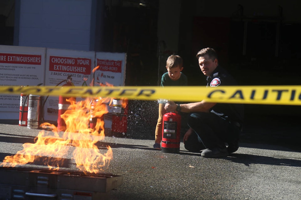 Kids got to practice using a fire extinguisher on a gas barbeque during Colwood Fire Rescue’s open house on Sunday (Sept. 25). (Bailey Moreton/News Staff)