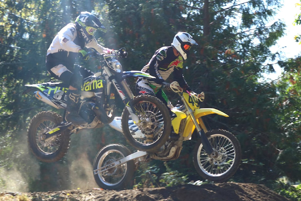 Riders fly over a jump at the start of the hill climb competition at the Victoria Motorcycle Club in Metchosin on Oct. 2. (Bailey Moreton/News Staff)