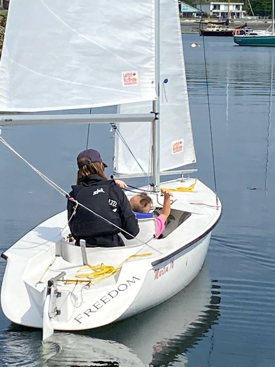 Hannah Steven, RVYC sailing staff, and her companion sailor, a DSA client, cruise in Cadboro Bay aboard Freedom a Martin 16 sailboat. (Courtesy Disabled Sailing Association Victoria)