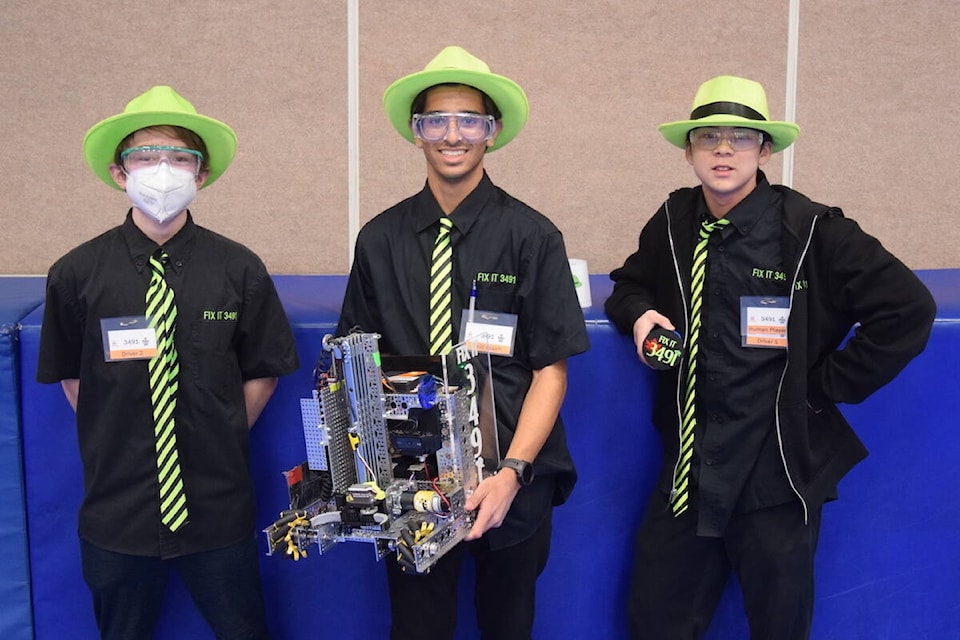 Community-based team FIX IT from Victoria featuring Kai Williams (from left), Amren Kareer and Bryce Kong prepares to compete at a FIRST Tech Challenge at St. Margaret’s School. (Brendan Mayer/News Staff)