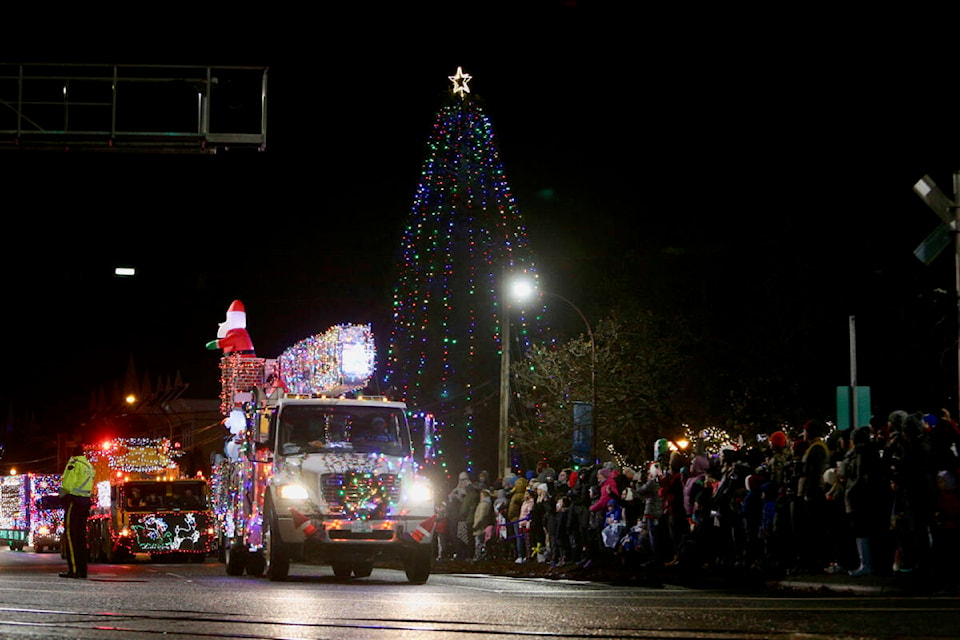 Hundreds of spectators young and old lined the intersection of Goldstream Avenue and Veterans Memorial Parkway to watch as the 24th annual IEOA Truck Light Convoy and Food Drive made its way through Langford Saturday (Dec. 3). (Justin Samanski-Langille/News Staff)