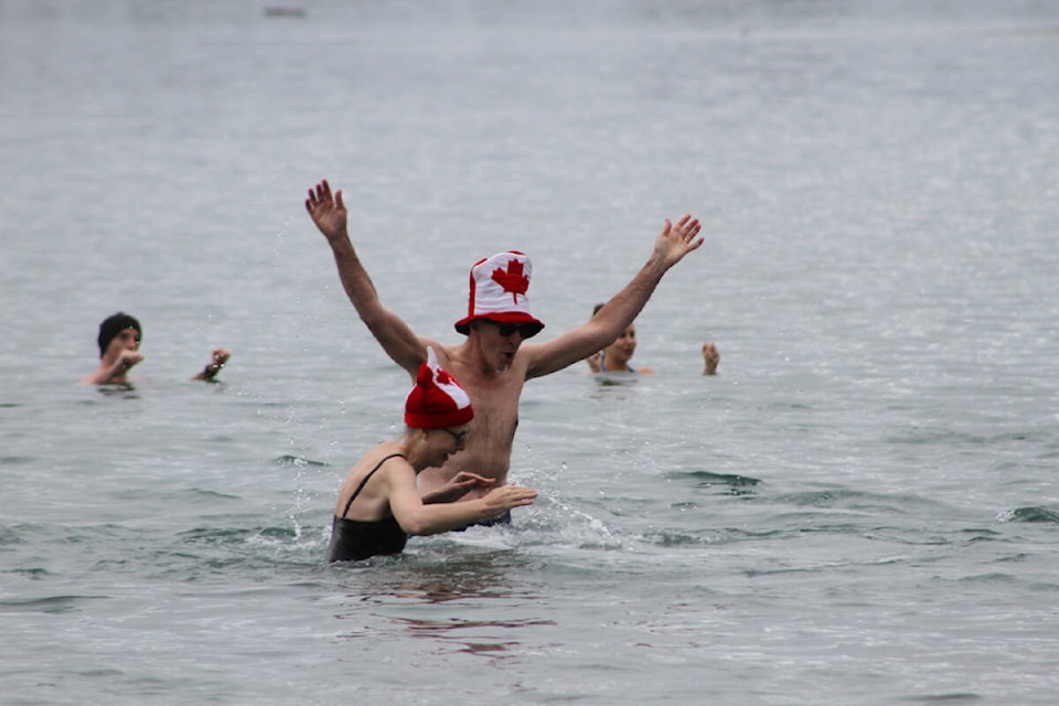 Swimmers sporting festive New Year’s attire enjoy a chilly dip at Willows Beach in Oak Bay on Sunday (Jan. 1). (Austin Westphal/News Staff)