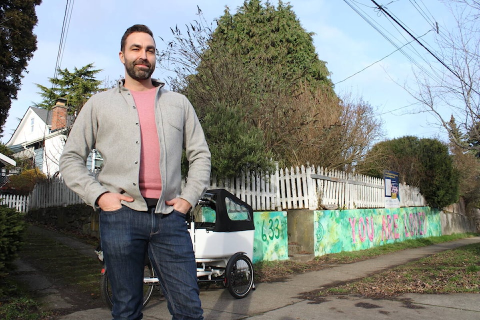 Julian West, founder of Urban Thrive, outside 633 Belton Avenue where his development company and Lapis Homes are looking to add a six-unit home that would have no off-street parking, but would aim to advance more sustainable urban transportation options. (Jake Romphf/News Staff)