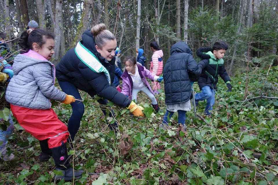 Miss Earth Canada Layanna Robinson, a Victoria resident, works alongside the students and community members March 9 in Mystic Vale at the University of Victoria. (Courtesy Greater Victoria Green Team)