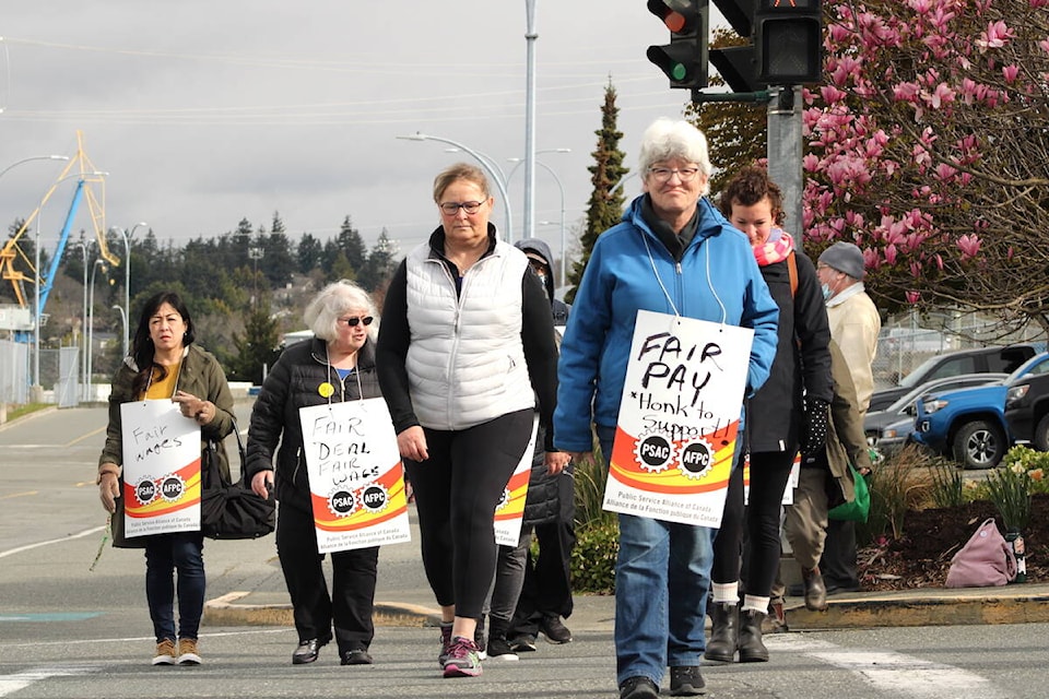 Federal civilian workers involved in CFB Esquimalt operations picketed outside the Greater Victoria naval base on April 19 as nationwide strike actions followed a missed deadline for a new deal to be struck. (Jake Romphf/News Staff)
