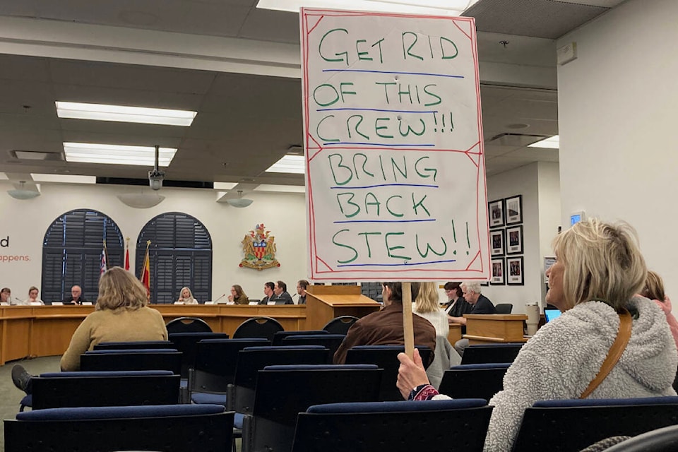 A lone protester holds a sign during Langford’s committee of the whole meeting on Tuesday (April 18). (Bailey Moreton/News Staff)