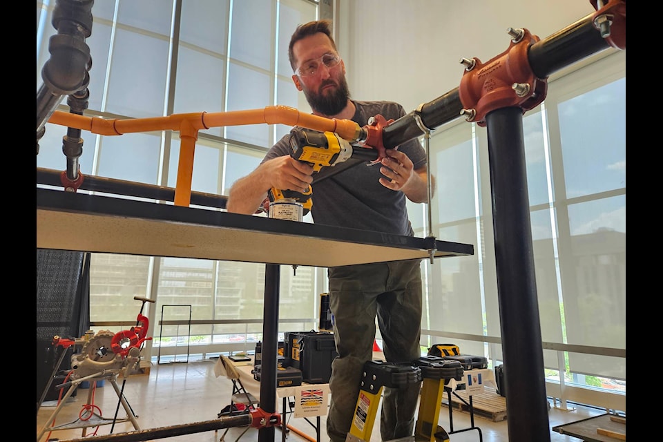 Evan Fraser competing in the Skills Canada National Competition in the sprinkler fitting competition. (Courtesy of Camosun College)