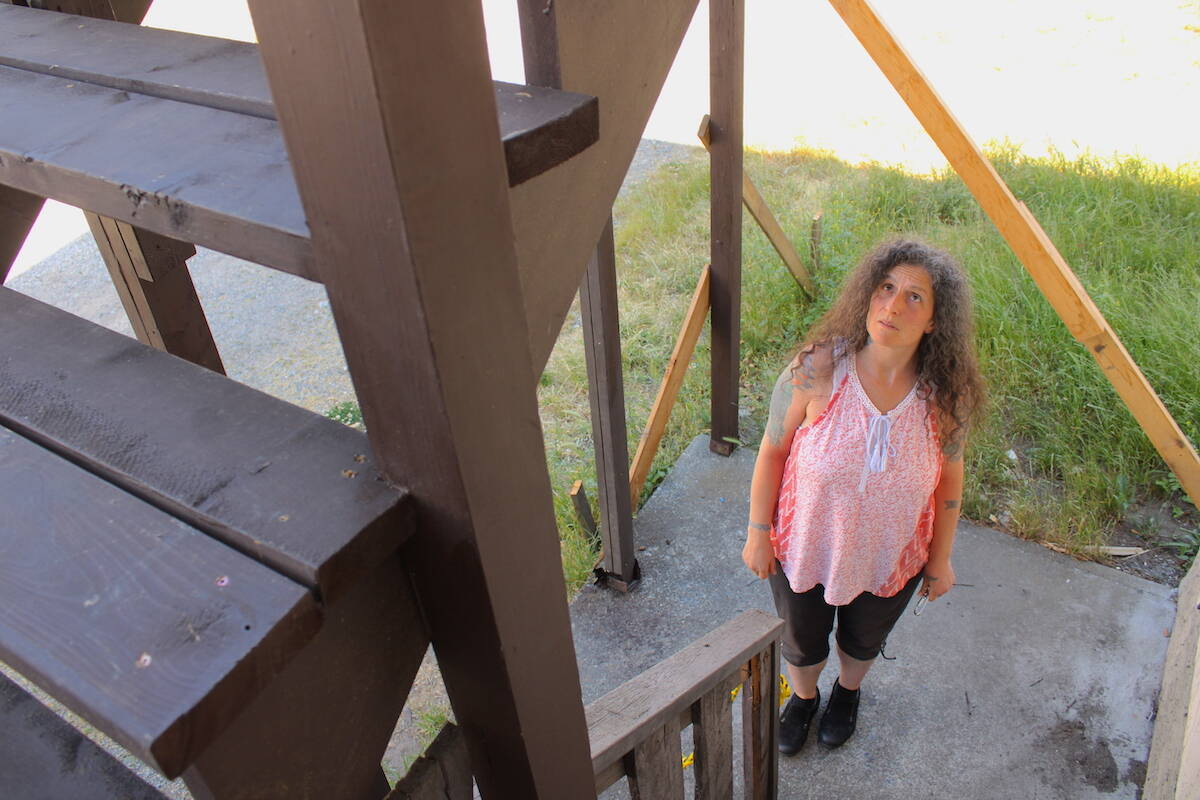 Kristianne Stone stands by the fire escape that she would need to use if a fire broke out at her Cook Street apartment building, but the stairway remains unsafe after months. (Jake Romphf/News Staff)