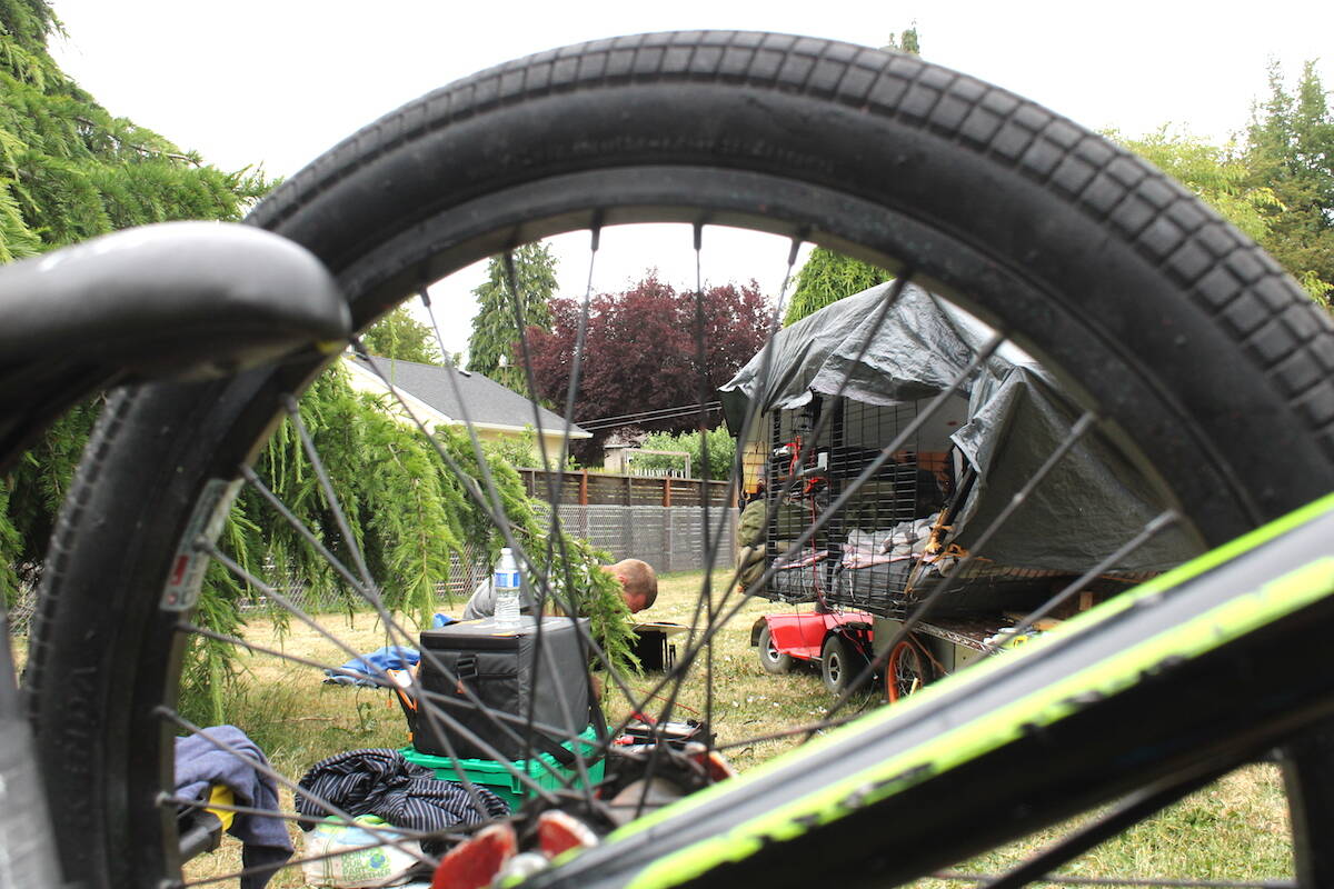 Cody (C.J.) Poole works on the solar-powered cart thats been his home for months. (Jake Romphf/News Staff)