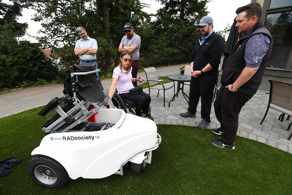 RAD Recreation Adapted Society founder Tanelle Bolt provides a training session for Highland Pacific Golf Course staff Tuesday, June 13, on the paragolfer. The device allows people with limited or no ability to stand on their own to navigate a golf course and be raised into a proper swinging position. (Justin Samanski-Langille/News Staff)