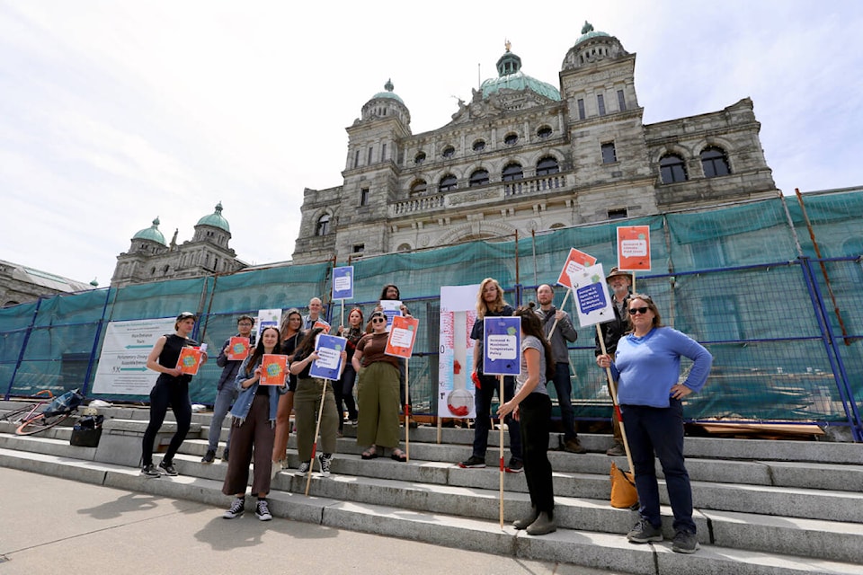 Demonstrators with the Worker Solidarity Network stand with a giant satirical thermometer during a demonstration in front of the B.C. legislature Saturday, June 17, calling on the government to make labour law changes to better protect workers in extreme heat. (Justin Samanski-Langille/News Staff)