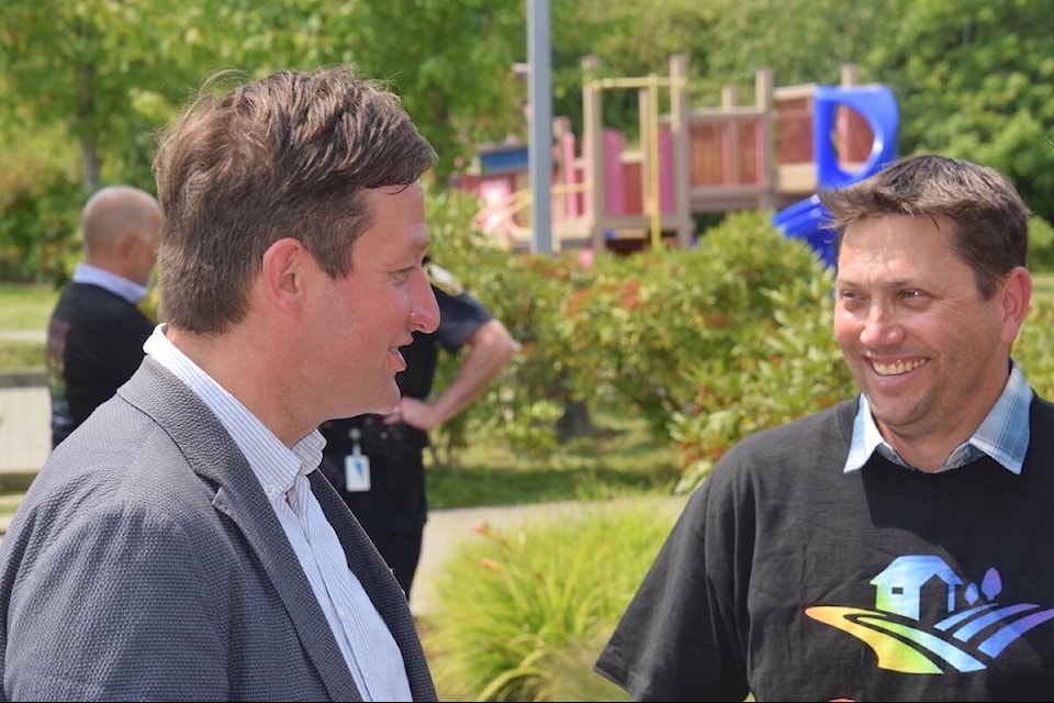 B.C.’s Minister of Transportation and Infrastructure Rob Fleming (left) talks to Central Saanich Coun. Gord Newton (right) at a press conference about the Keating flyover overpass on Tuesday (July 4) at the Central Saanich Fire Department. (Brendan Mayer/News Staff)