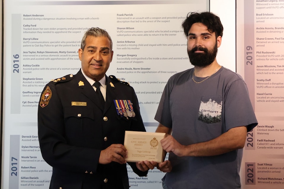 Chief Const. Del Manak, left, presents a Civic Service Award to Sage Lathrop.