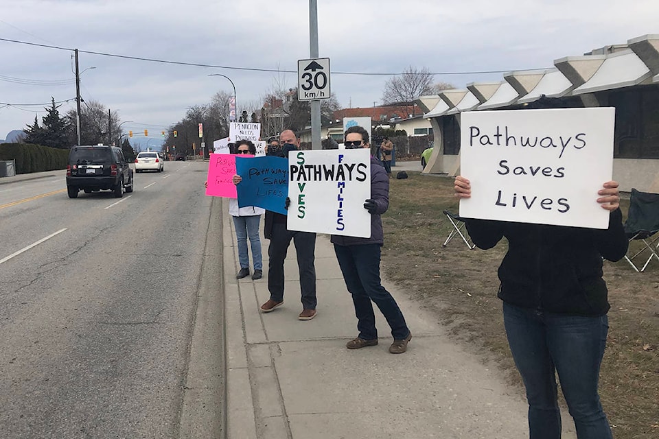 More than 40 people with signs demonstrated their support outside Pathways Addictions Resource Centre on Sunday. (Monique Tamminga Western News)