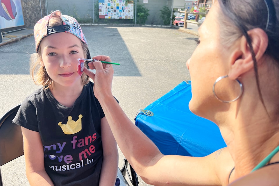 Tiffany Jorgenson paints Grace Walters' face at the Downtown Williams Lake Art Walk opening event on Aug. 9.