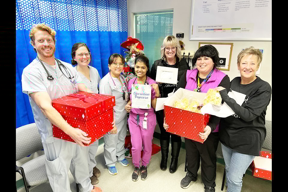 Volunteers with BC Transplant, and family of an organ donor now passed-on, thank health-care workers at the Cariboo Memorial Hospital by gifting them with a box of popcorn. Dr. Mike Garrard (from left), Mandy Simpson, Juliet Oakley, Steffy Varghese, Deanna Desjarlais, Brielle Gagnon and Debbie Lynn.