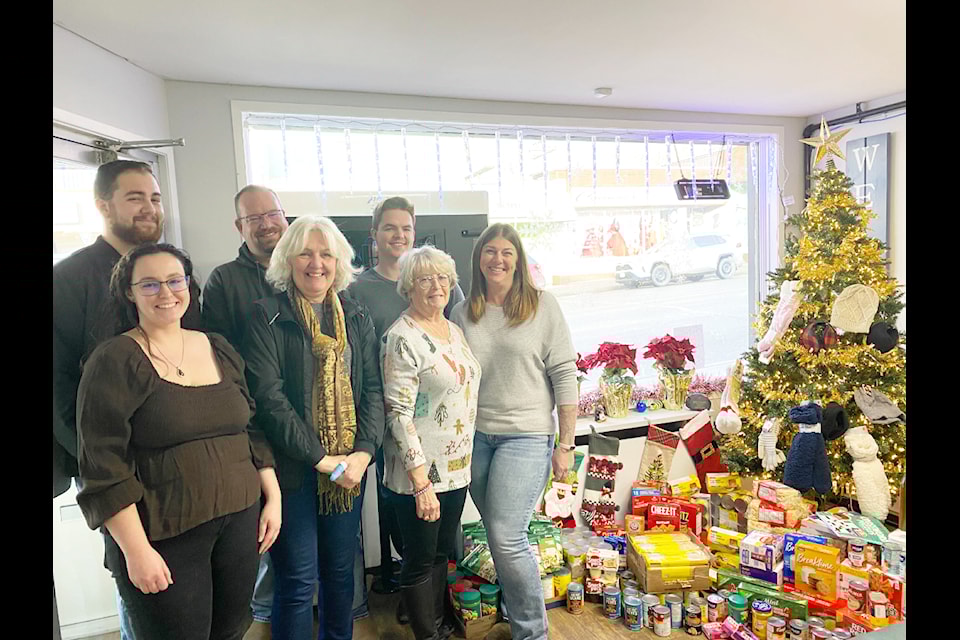 The Crosina Realty team, from left to right, back: Mark Johnson, Jason Noble, Tim Johnson. From left to right, front: Garnett Roberts, Eva Navrot of the Seniors' Activity Centre, Karen Gertzen and Marilyn Martin. 