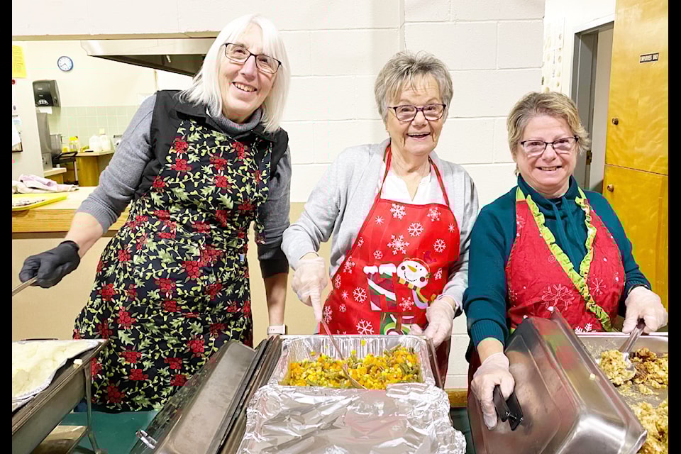 The annual CDC Yuletide Dinner is made possible by the many people who donate their time and money so everyone can enjoy a holiday dinner, including Society of Saint Vincent de Paul members Eva Hoelzler, left, Paulette Hrynkewich and Jane Straub. 