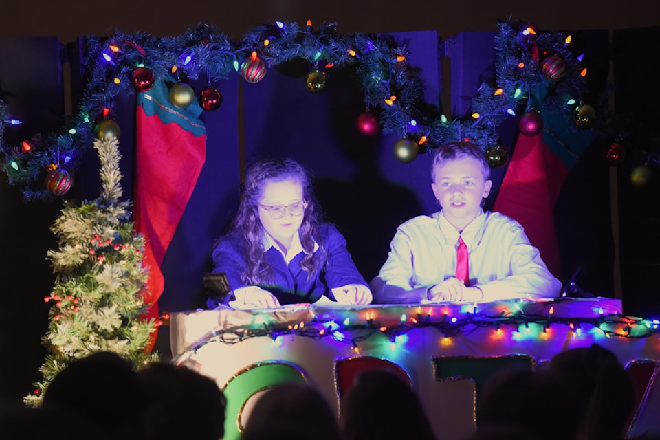 Jaxon Graham and Chanel Roe broadcast live coverage of Santa's journey for the Chilcotin Road Elementary Christmas concert.