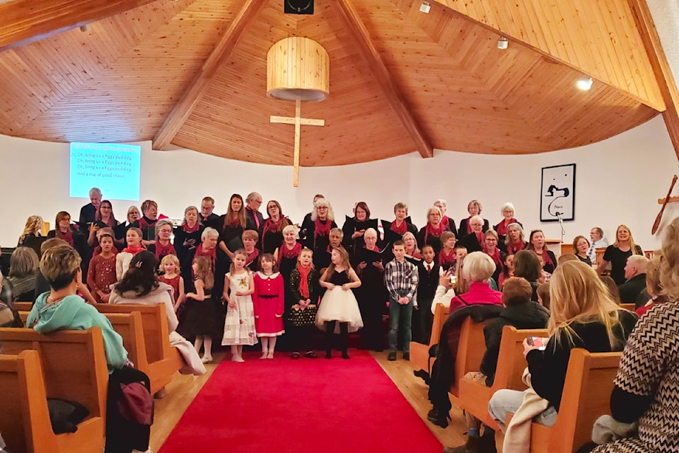 Singers of all ages gather to sing We Wish You a Merry Christmas to close off the Tuba Christmas concert Tuesday, Dec. 3 at St. Andrew's United Church. 