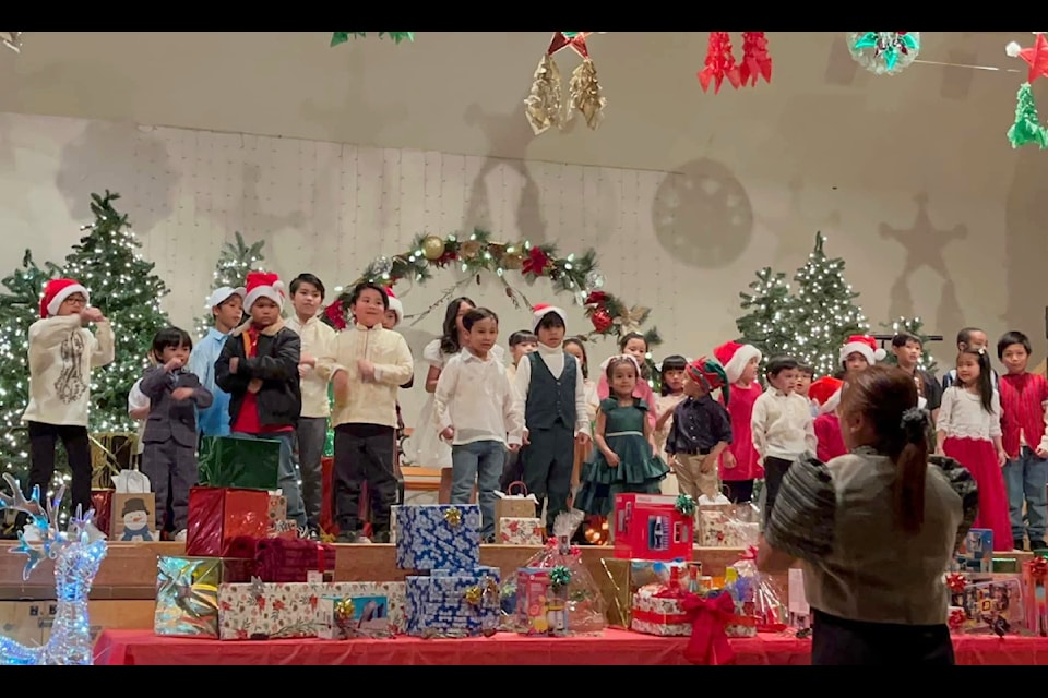 Children sing Jingle Bells during the Filipino community Christmas party Dec. 8, 2024 at Sacred Heart Catholic Hall. 