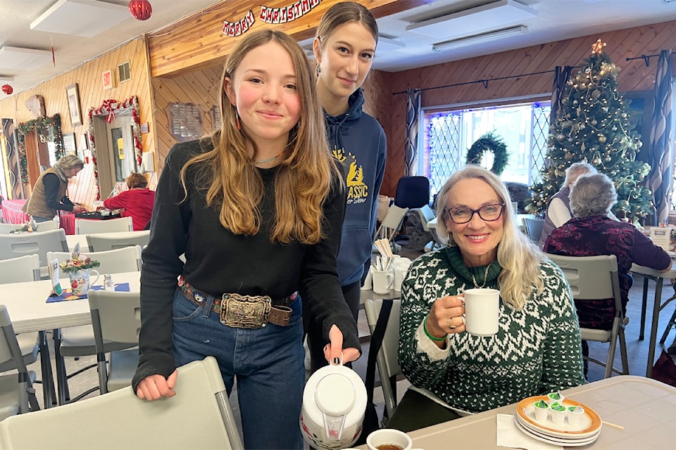Sloan Fuller, from left, and Katy Jasper help serve at the seniors centre, while Faye Johnston enjoys her cuppa.