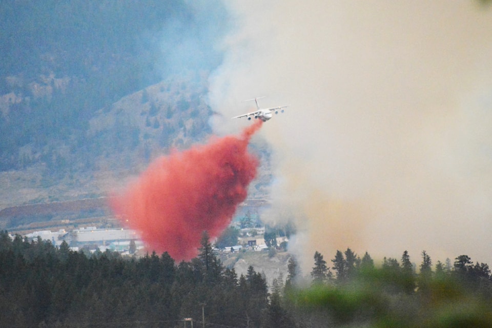 An air tanker drops fire retardant on the wildfire in the Williams Lake River Valley Sunday, July 21.