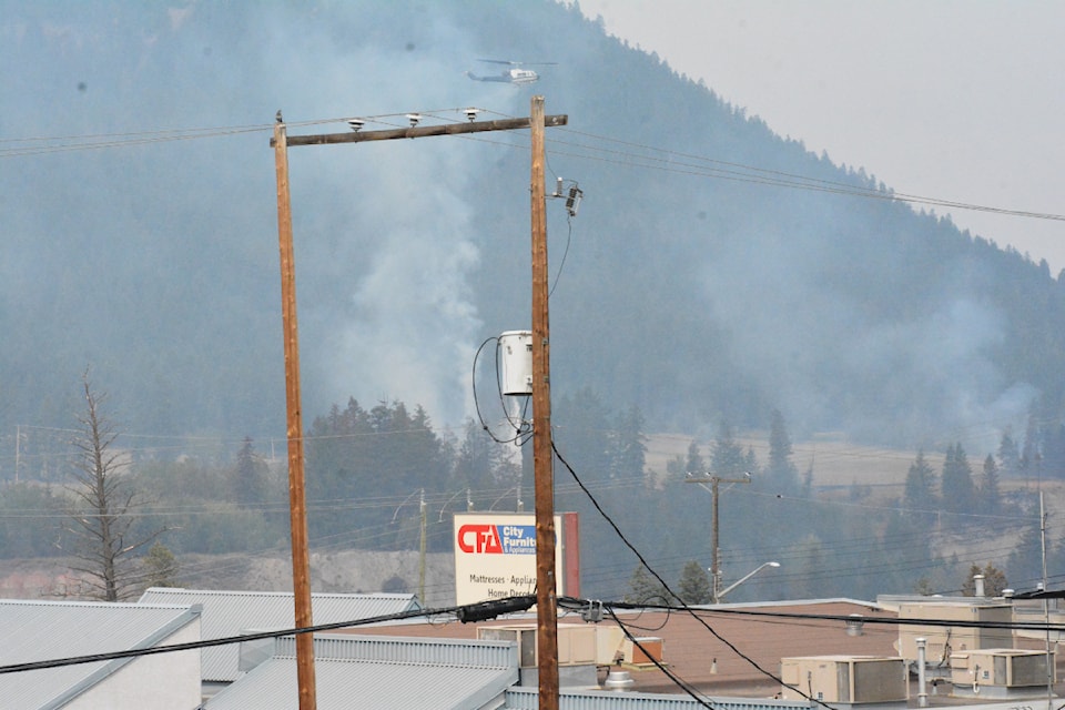The city has closed water access to Williams Lake so emergency aircraft can access water. Here one of several helicopters drops water on the west bench above the river valley Monday, July 22.  