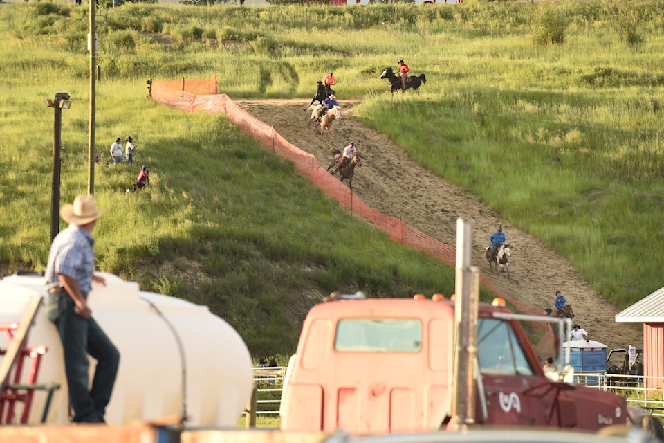 The Mountain Race competitors race down the steep section of the course towards the Stampede Grounds in a 2022 mountain race event. 