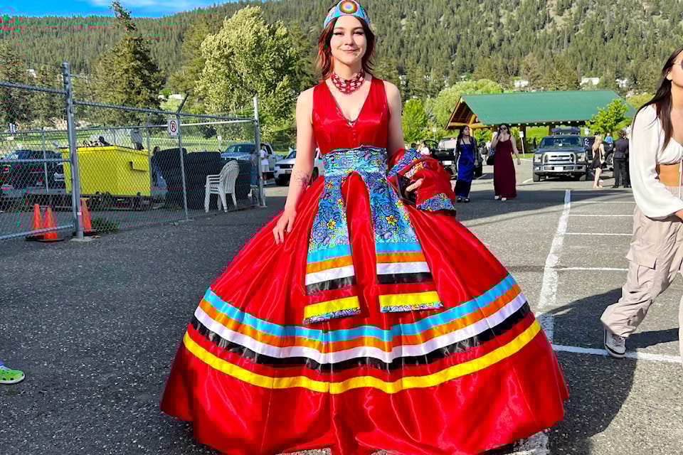 Kaden Napoleon displays her custom grad dress she designed with local seamstress Tanis Armstrong for her 2024 grad. 