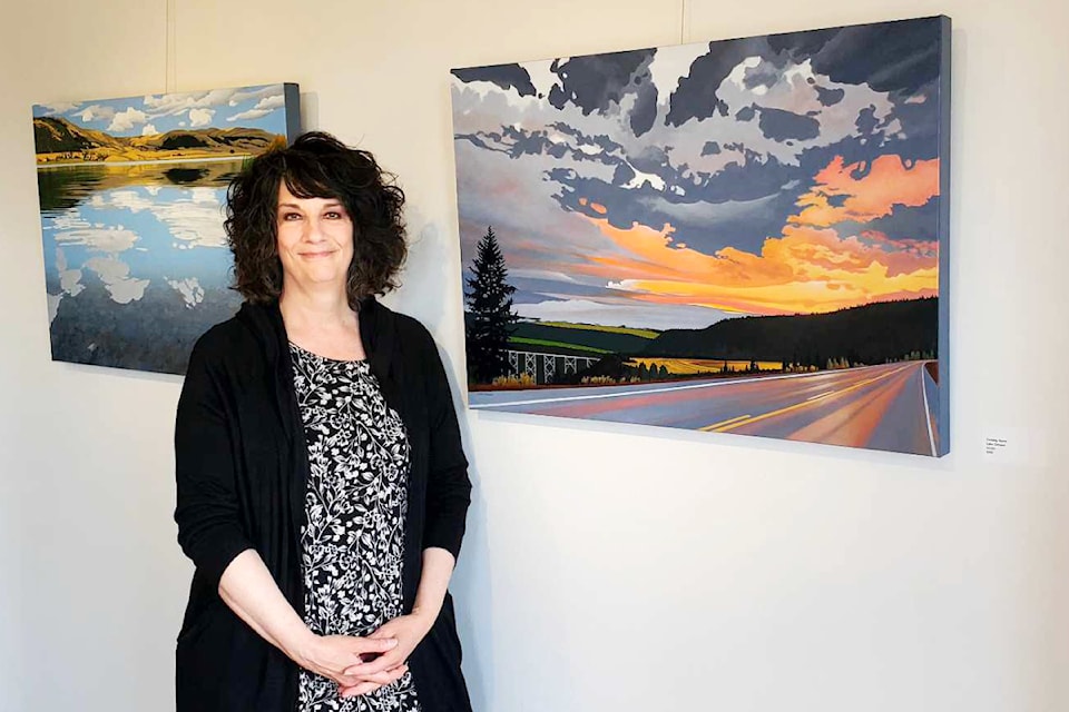 Prince Rupert artist Lynn Cociani stands with her painting Coming Home during the opening of her exhibit at the Station House Gallery in Williams Lake Thursday, June 6, 2024