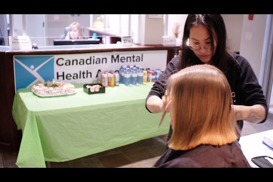 A community member gets a free haircut by Julie Inthapagna at an event organized by the Williams Lake Community Action Team for the unhoused. 
