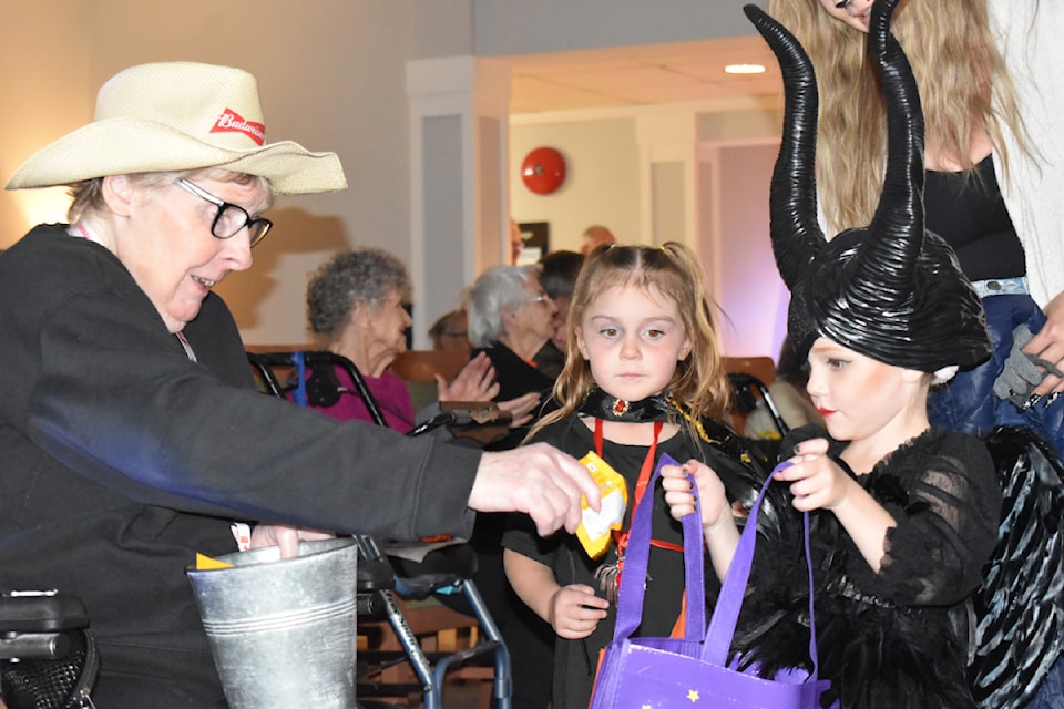 Maleficent spooks seniors on Halloween while trick-or-treating at the Williams Lake Seniors Village.