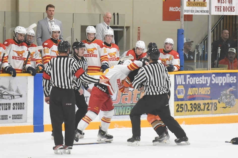 Dawsom Thomas of the Williams Lake Mustangs tangled with a Rebel player in the third period.