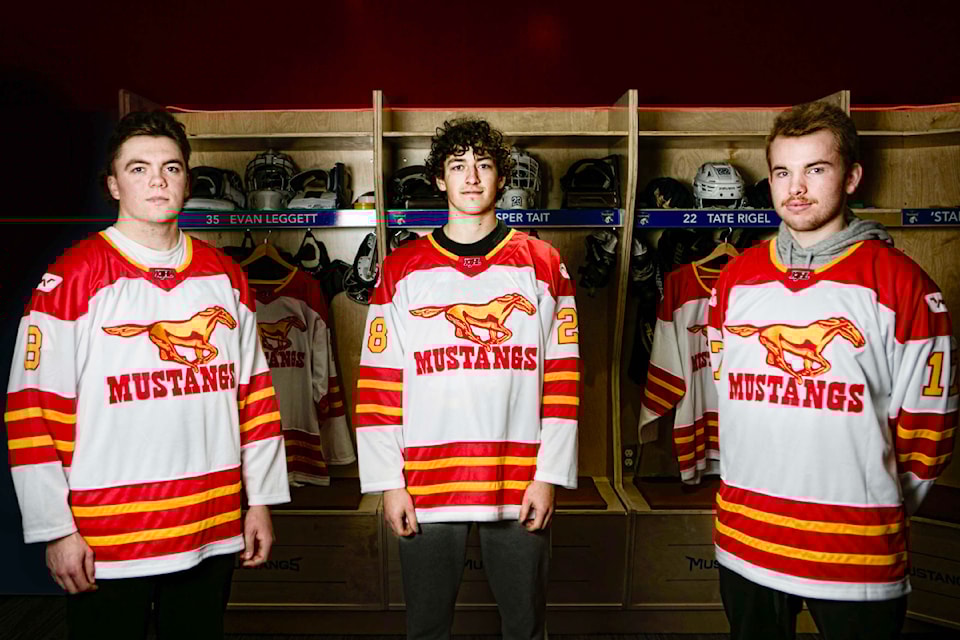 Williams Lake Mustangs team members Kaden Ernst, left, Madden Aubie and Evan Leggett wear the team's retro jerseys in advance of their Saturday, Oct. 19, alumni game. 