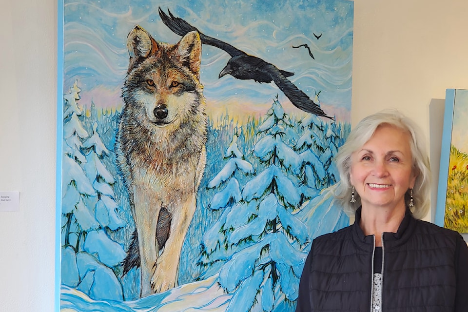 Cariboo artist Georgie Lesley  stands with her painting An Ancient Relationship, part of a new exhibit at the Station House Gallery. 