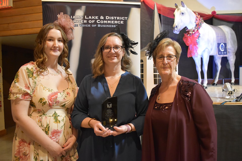 Madison Batty, left, and Krista Harvey of BGC Williams Lake accept the Williams Lake and District Chamber of Commerce Business Excellence Not-for-Profit Award, presented by chamber director MJ Vigeant on Saturday, Oct. 26. 