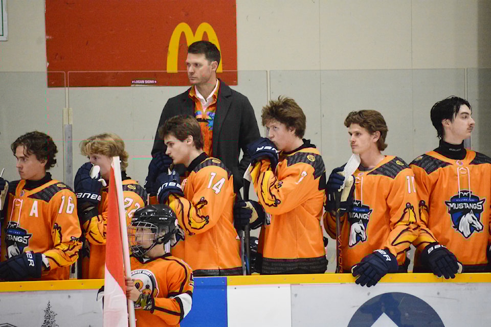 Mustangs head coach and manager Tyrel Lucas wears a ribbon shirt Friday, Sept. 27 on the bench in Williams Lake. 