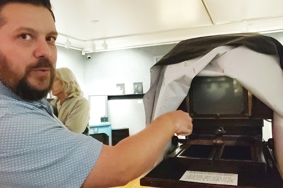 Williams Lake artist Rick Magnell stands with he 1920 Kodak studio camera he uses to create ambrotype photographs. 