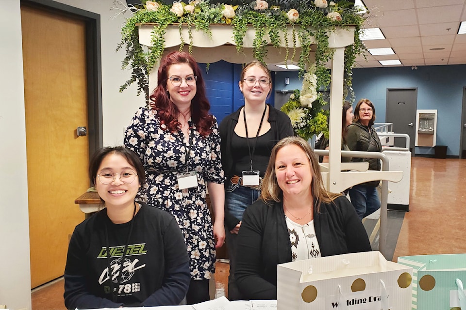 Kristen Blackwood, back left, Abby Ostrom, Ivy Nguyen, front left, and Abby Shoults welcome visitors to the Cariboo Wedding and Grad Show on Saturday, Oct. 5 at Thompson Rivers University Williams Lake Campus. 