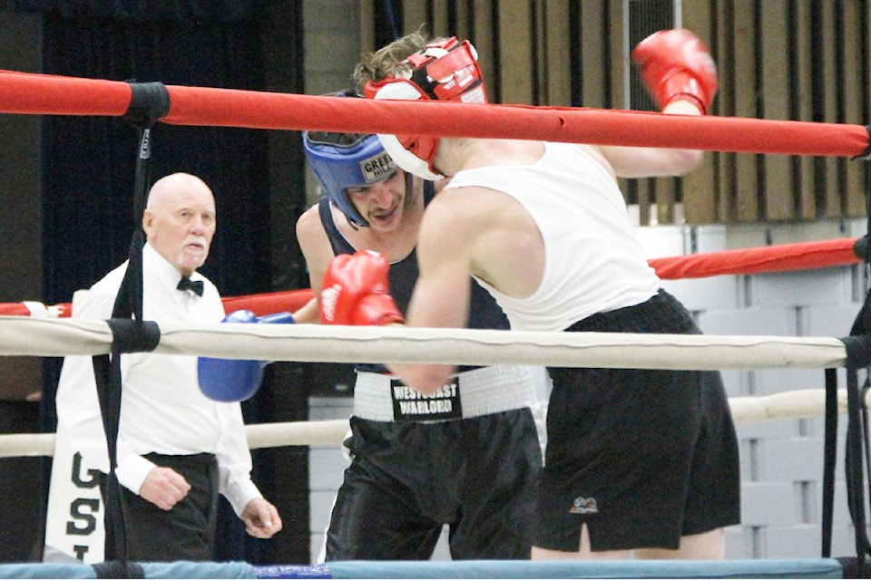 Williams Lake boxer Duncan McLellan (blue helmet) competes against Landon Beazley of Salmon Arm at the Ian Gibson Tribute Boxing Show Sept. 21, 2024 in Vernon. 