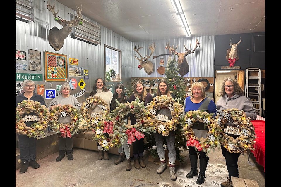 Eight women enjoy a burlap wreath making workshop offered by Sarah Parker of Horsefly.