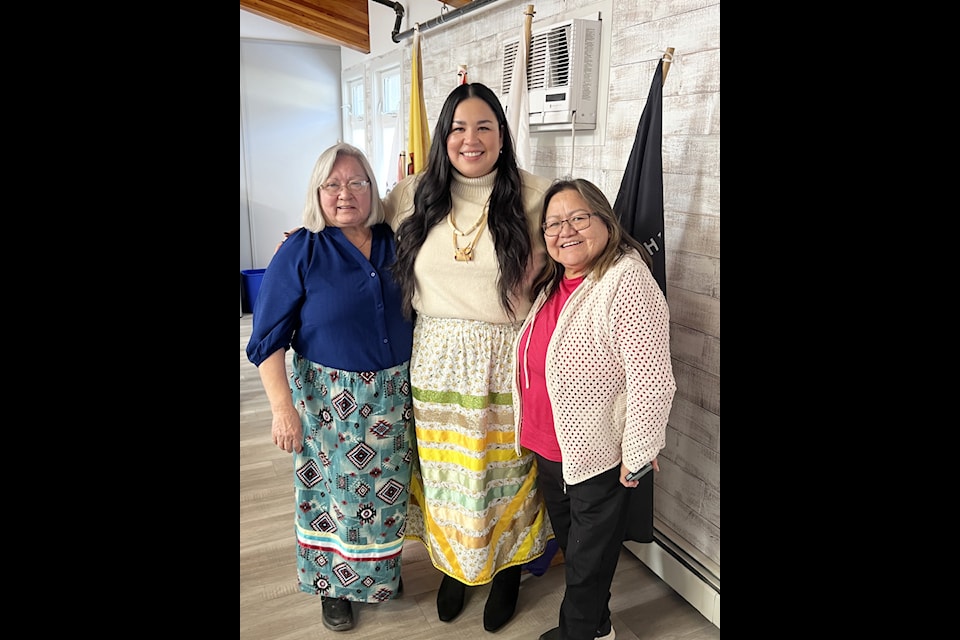 Doreen M. Johnson, Cara Basil and Irene Johnson celebrate after Basil successfully defended her masters' thesis on site in Esk'etemc. 
