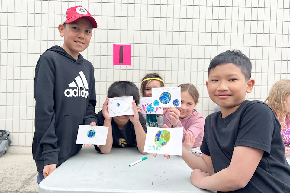 A group of Cataline Elementary School students show their completed seed cards, which they can plant to grow wildflowers.