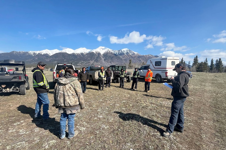 Tin Towh firefighters have a tailgate meeting near the fireline in Nemaiah Valley.