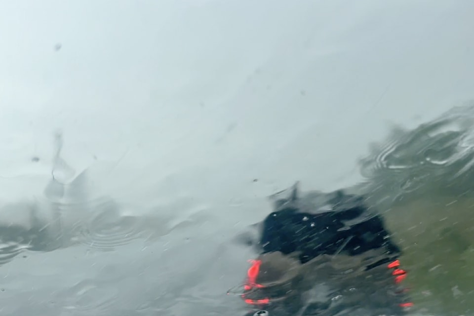 Storm stops traffic briefly as drivers wait for heavy rain, hail to pass.