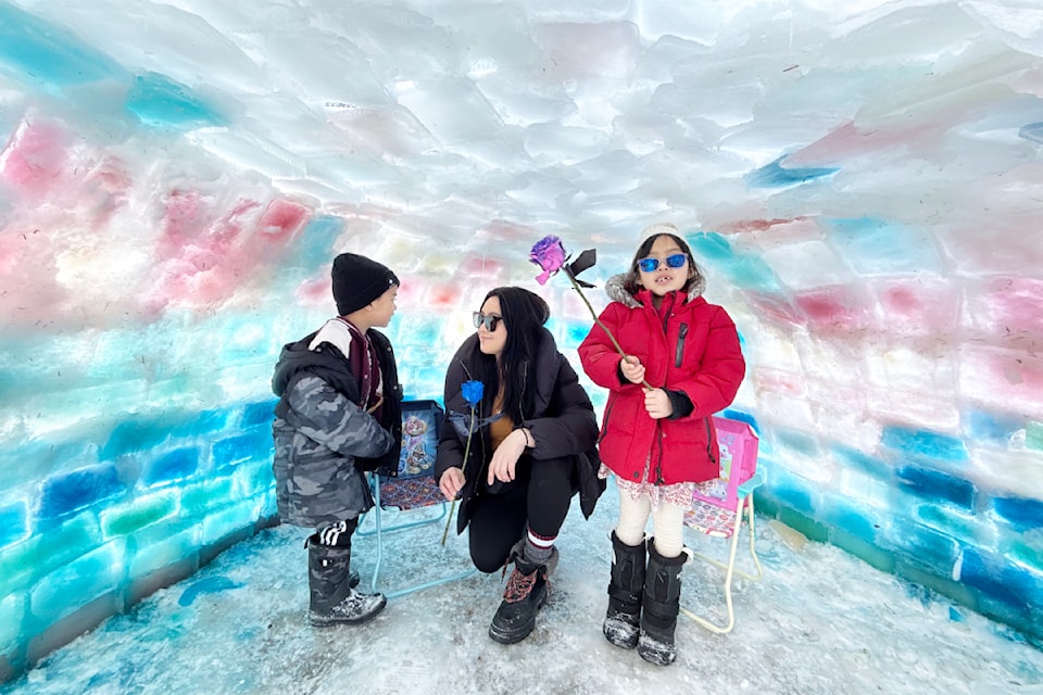 Erika Tenorio, centre, with her children Mateo and Tori, inside an igloo-like structure they made in their yard.