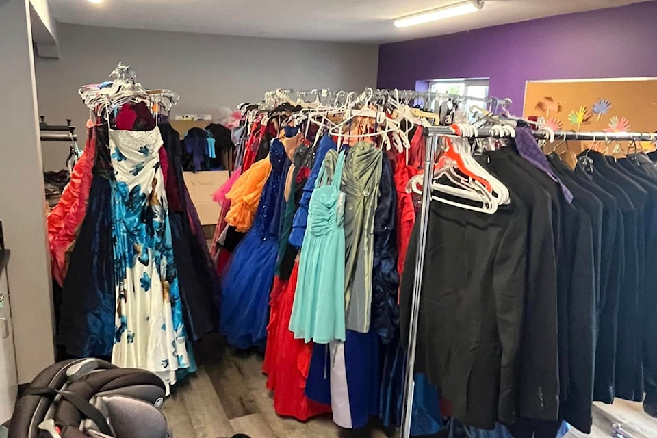 Glass Slipper Boutique dresses and tuxes at a pop-up event.